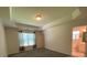 Main bedroom with tray ceiling, carpet, and ensuite bathroom with natural light at 7517 Whispering Oak Dr, Hanahan, SC 29410