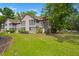 Scenic backyard view of a townhouse featuring a well-manicured lawn near a tranquil pond at 7921 Cricket Ct # 305 E, North Charleston, SC 29418