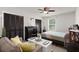 Cozy bedroom with comfortable seating, a ceiling fan, neutral tones, and ample closet space at 7921 Cricket Ct # 305 E, North Charleston, SC 29418
