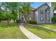 Charming two-story townhouse with gray and brown siding, steps, and a well-maintained lawn at 7921 Cricket Ct # 305 E, North Charleston, SC 29418