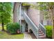 Charming two-story townhouse with gray and brown siding, steps, and a well-maintained lawn at 7921 Cricket Ct # 305 E, North Charleston, SC 29418