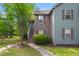Charming two-story townhouse with gray and brown siding, steps, and a well-maintained lawn at 7921 Cricket Ct # 305 E, North Charleston, SC 29418