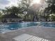 Sparkling community pool with ample seating surrounded by lush greenery for a relaxing outdoor experience at 7921 Cricket Ct # 305 E, North Charleston, SC 29418