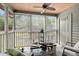 Relaxing screened-in porch featuring comfortable seating, a ceiling fan, and a tranquil view at 7921 Cricket Ct # 305 E, North Charleston, SC 29418