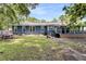 Well-lit backyard shows mature trees, a gray roof, and the home's light blue siding at 809 O'Sullivan Dr, Mount Pleasant, SC 29464