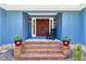 An inviting entryway with brick steps, double doors, and potted plants creates a warm welcome at 809 O'Sullivan Dr, Mount Pleasant, SC 29464