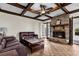 A cozy living room featuring a brick fireplace, wooden ceiling beams, and stylish furniture at 809 O'Sullivan Dr, Mount Pleasant, SC 29464