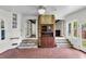 Bright sun room boasting brick floors, lots of windows, and a charming vintage hutch at 809 O'Sullivan Dr, Mount Pleasant, SC 29464
