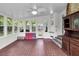 Bright sunroom features large windows, red-tiled floor, and ceiling fan at 809 O'Sullivan Dr, Mount Pleasant, SC 29464