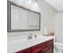 Bathroom with dark wood cabinets, white countertops, tile flooring, and a large framed mirror at 9524 Markley Blvd, Summerville, SC 29485