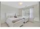Bright bedroom with twin beds featuring bright white bedding and a window offering natural light at 9524 Markley Blvd, Summerville, SC 29485