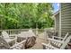 Spacious deck with white Adirondack chairs and grill, perfect for outdoor entertaining and enjoying the serene backyard at 9524 Markley Blvd, Summerville, SC 29485