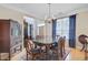 Elegant dining room with classic furniture, a glass-top table, and a view into the living area at 9524 Markley Blvd, Summerville, SC 29485