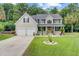 Charming two-story home with a well-manicured lawn, a two-car garage, and inviting front porch at 9524 Markley Blvd, Summerville, SC 29485