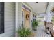 Close-up of a charming front porch featuring a decorative wreath and potted plants at 9524 Markley Blvd, Summerville, SC 29485