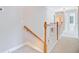 Hallway with neutral carpet, wood railing, and light gray paint at 9524 Markley Blvd, Summerville, SC 29485