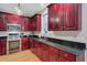 Well-equipped kitchen with dark wood cabinets, stainless steel appliances, and ample countertop space at 9524 Markley Blvd, Summerville, SC 29485