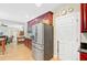 Modern kitchen with stainless steel refrigerator and dark cabinets adjacent to dining space at 9524 Markley Blvd, Summerville, SC 29485