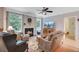 Inviting living room with a cozy fireplace, plush seating, and natural light from large windows at 9524 Markley Blvd, Summerville, SC 29485