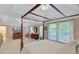 Expansive primary bedroom with tray ceilings, fan, television and furnishings offers an abundance of space at 9524 Markley Blvd, Summerville, SC 29485