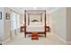Primary bedroom featuring a four-poster bed, side tables and lamps, complemented by natural light at 9524 Markley Blvd, Summerville, SC 29485