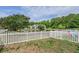 Backyard features a scenic pond view, white picket fence, and lush greenery, creating a serene outdoor space at 1003 Washitonia Way # A, Charleston, SC 29492