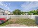 Spacious backyard with a white picket fence and mature trees providing shade at 1003 Washitonia Way # A, Charleston, SC 29492