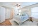 Bright bedroom with wood-look floors, white metal bed frame, a ceiling fan, and natural light at 1003 Washitonia Way # A, Charleston, SC 29492