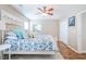 Comfortable bedroom featuring wood-look floors, white metal bed frame with patterned bedding, and a ceiling fan at 1003 Washitonia Way # A, Charleston, SC 29492