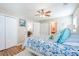 Cozy bedroom with a ceiling fan, wood-look floors, and a white metal bed frame with patterned bedding at 1003 Washitonia Way # A, Charleston, SC 29492