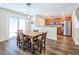 Inviting dining area with hardwood floors, kitchen access, and natural lighting at 1003 Washitonia Way # A, Charleston, SC 29492