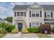 Inviting townhome with well-maintained landscaping, dark shutters, and a quaint entrance at 1003 Washitonia Way # A, Charleston, SC 29492