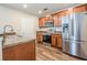 Modern kitchen with stainless steel appliances, wood cabinets, and wood-look floors at 1003 Washitonia Way # A, Charleston, SC 29492