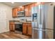 Modern kitchen with stainless steel appliances and warm wood cabinets at 1003 Washitonia Way # A, Charleston, SC 29492