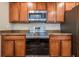 Close-up of the kitchen featuring stainless steel appliances and wood cabinets at 1003 Washitonia Way # A, Charleston, SC 29492