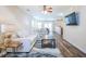 Comfortable living room featuring hardwood floors, a ceiling fan, and lots of natural light at 1003 Washitonia Way # A, Charleston, SC 29492