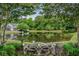 Relax by the serene pond surrounded by lush greenery and mature trees, offering a peaceful retreat at 1003 Washitonia Way # A, Charleston, SC 29492