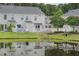 Townhome backyard overlooking a tranquil pond, complete with white picket fence and lush landscaping at 1003 Washitonia Way # A, Charleston, SC 29492