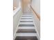 Staircase with dark wood treads and white risers, complemented by a wood handrail at 1003 Washitonia Way # A, Charleston, SC 29492