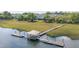 Picturesque dock with covered seating on calm water surrounded by lush greenery at 1022 Hunley Waters Cir, North Charleston, SC 29405