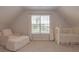 Bedroom with a window, armchair, and crib at 1022 Hunley Waters Cir, North Charleston, SC 29405