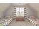 Attic bedroom featuring two beds with a window at 1022 Hunley Waters Cir, North Charleston, SC 29405