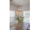 Bright dining area with elegant chandelier and large windows, creating a cozy atmosphere for meals and gatherings at 1022 Hunley Waters Cir, North Charleston, SC 29405