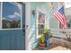 Inviting front porch with plants and an American flag, offering a warm welcome and classic charm at 1022 Hunley Waters Cir, North Charleston, SC 29405