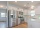 Modern kitchen with stainless steel appliances, white cabinets, and subway tile, offering a stylish and functional space at 1022 Hunley Waters Cir, North Charleston, SC 29405