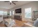 Stylish living room with comfortable seating, modern decor, and a large TV, perfect for relaxation and entertainment at 1022 Hunley Waters Cir, North Charleston, SC 29405