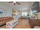 Inviting open-concept living room featuring a leather sofa, accent chair and seamless flow to the modern kitchen at 1022 Hunley Waters Cir, North Charleston, SC 29405