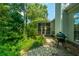 Charming backyard with stone walkway, screened porch, and outdoor grill at 104 S Ansel Xing, Goose Creek, SC 29445