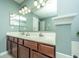 Bathroom boasting double sink vanity with dark wood cabinets and an ample mirror at 104 S Ansel Xing, Goose Creek, SC 29445