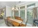 Inviting dining area with wood table, bench seating, chandelier lighting, and a wall of bright windows at 104 S Ansel Xing, Goose Creek, SC 29445